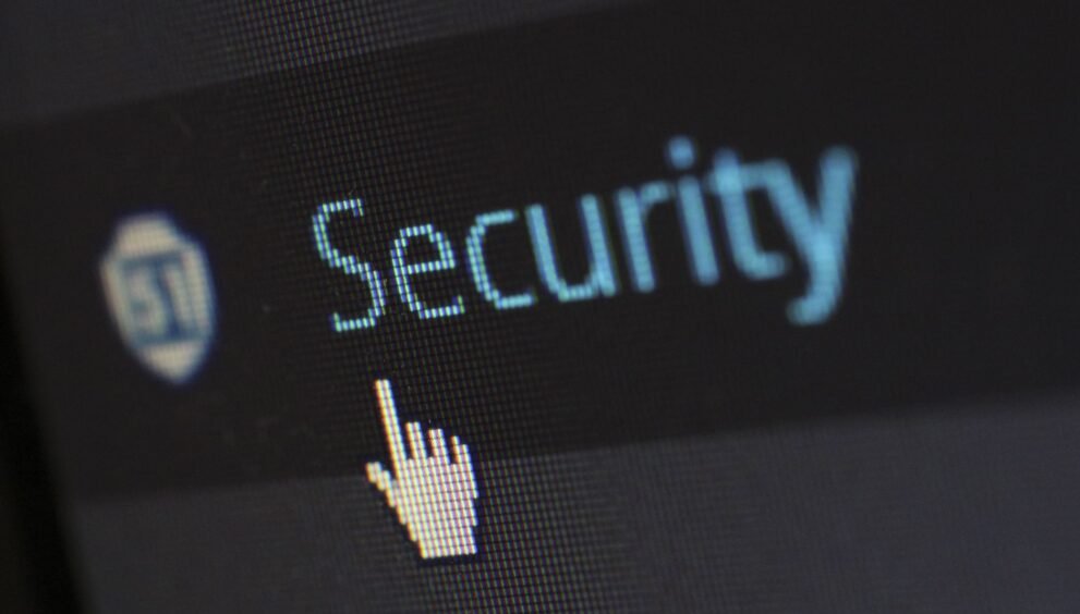 Close-up view of a mouse cursor over digital security text on display.